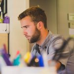 Man, work, desk — Stable IPTV Services Offering Smooth and Reliable Streaming Without Interruptions